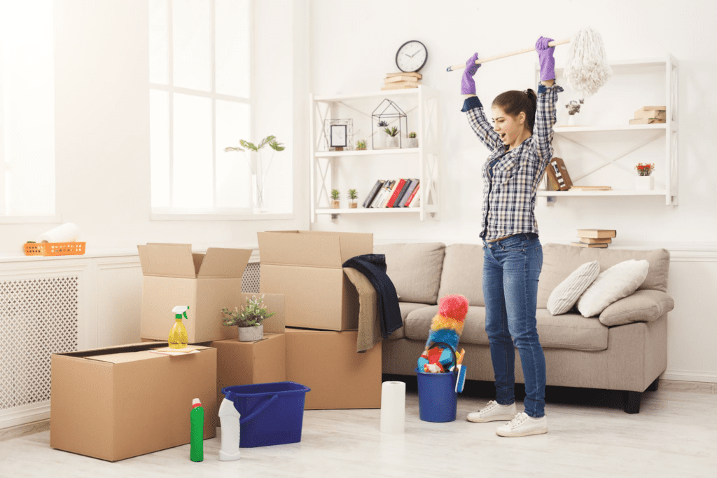 woman raising hands up after packing boxes