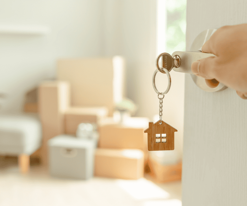 a person with a key moving into a new home